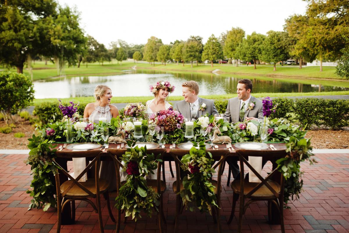 Bride and Groom and Wedding Party Members Seated at Table