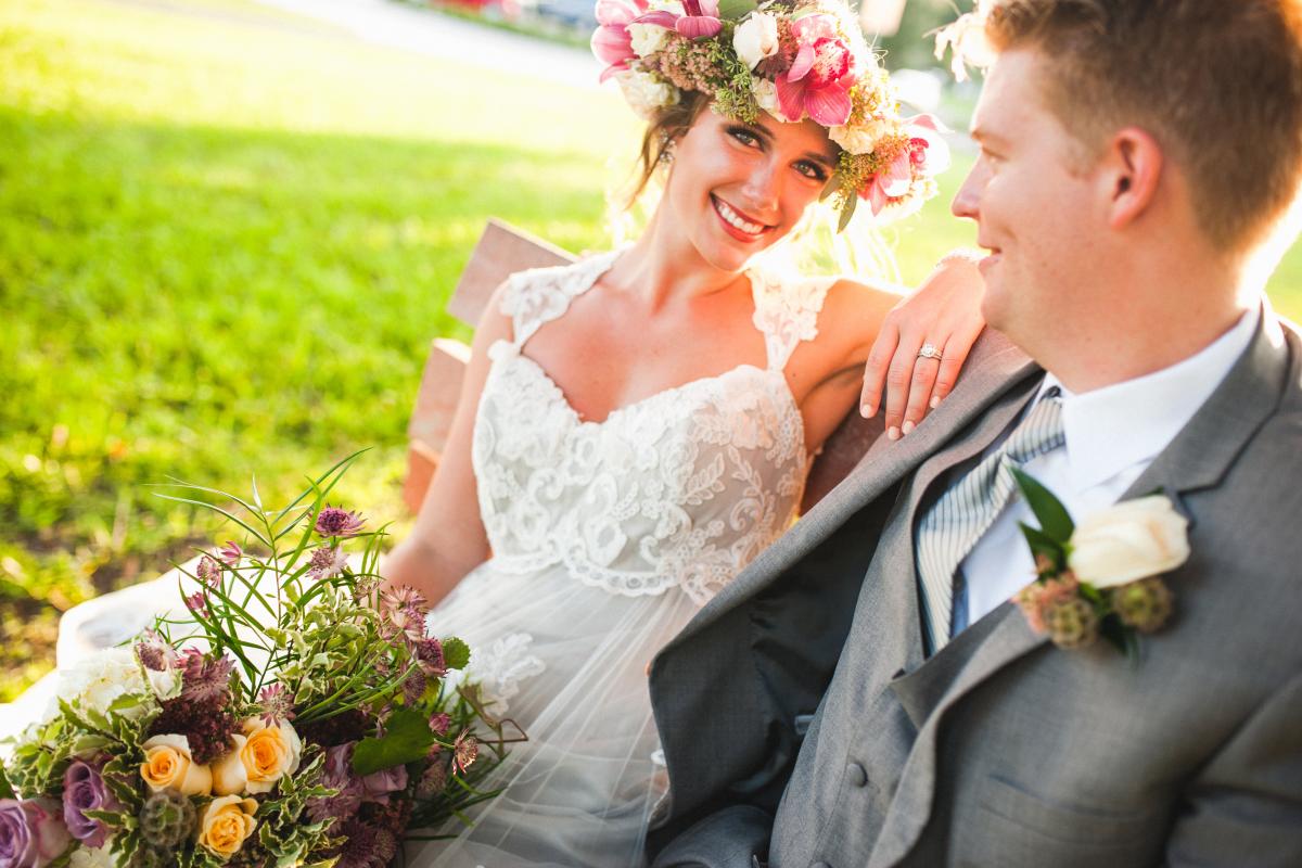 Bride and Groom Seated on Bench Outdoors