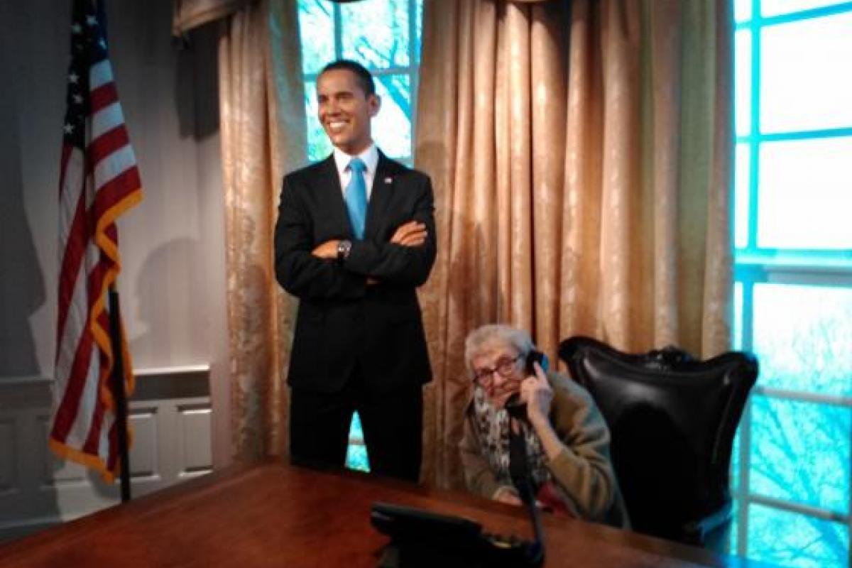 Woman Posing for Photo with Wax Figure of Barack Obama