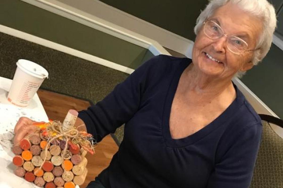 Woman Crafting a Pumpkin Made of Corks