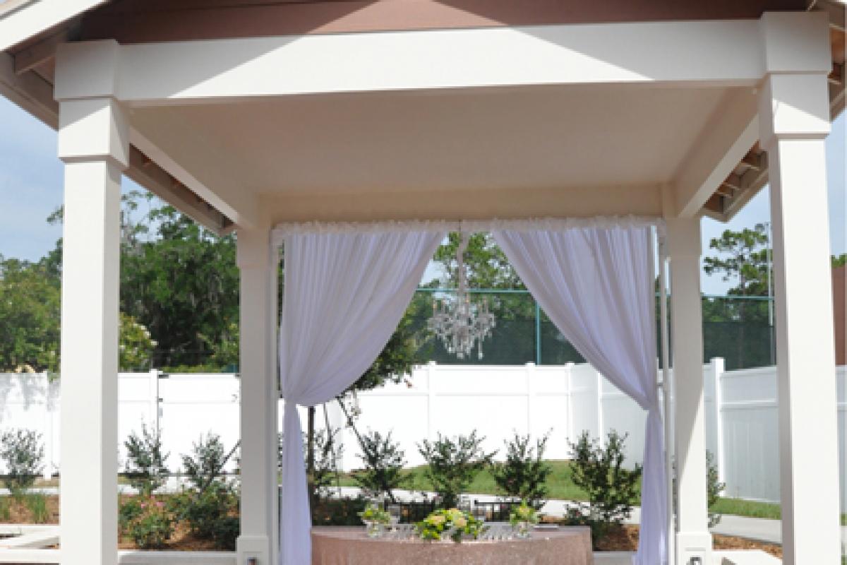 Courtyard Gazebo with White Drapes and Fence
